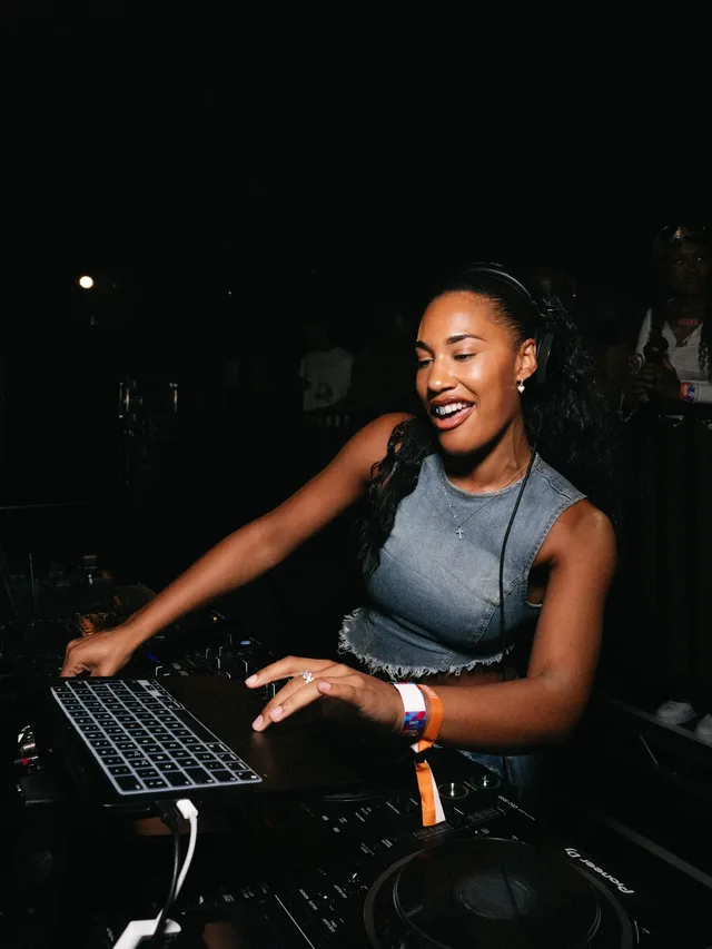 A DJ smiling behind the decks at Stepps.