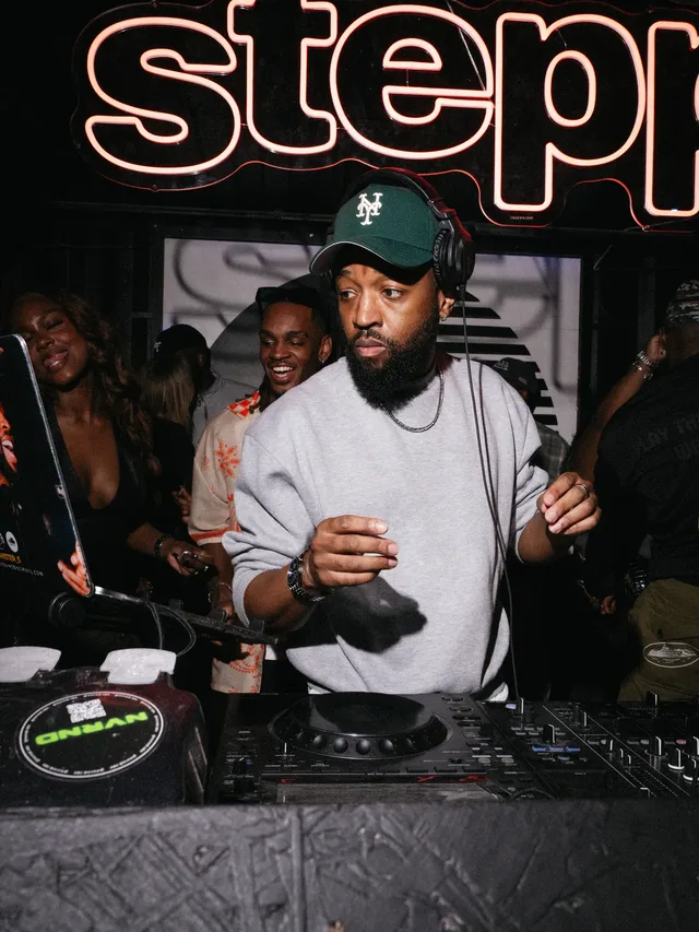 A DJ behind the decks beneath the Stepps sign.